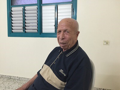 Misbah Ballour poses in his house in Alnusierat refugee camp (Photo: Yousef M. Aljamal, PC)